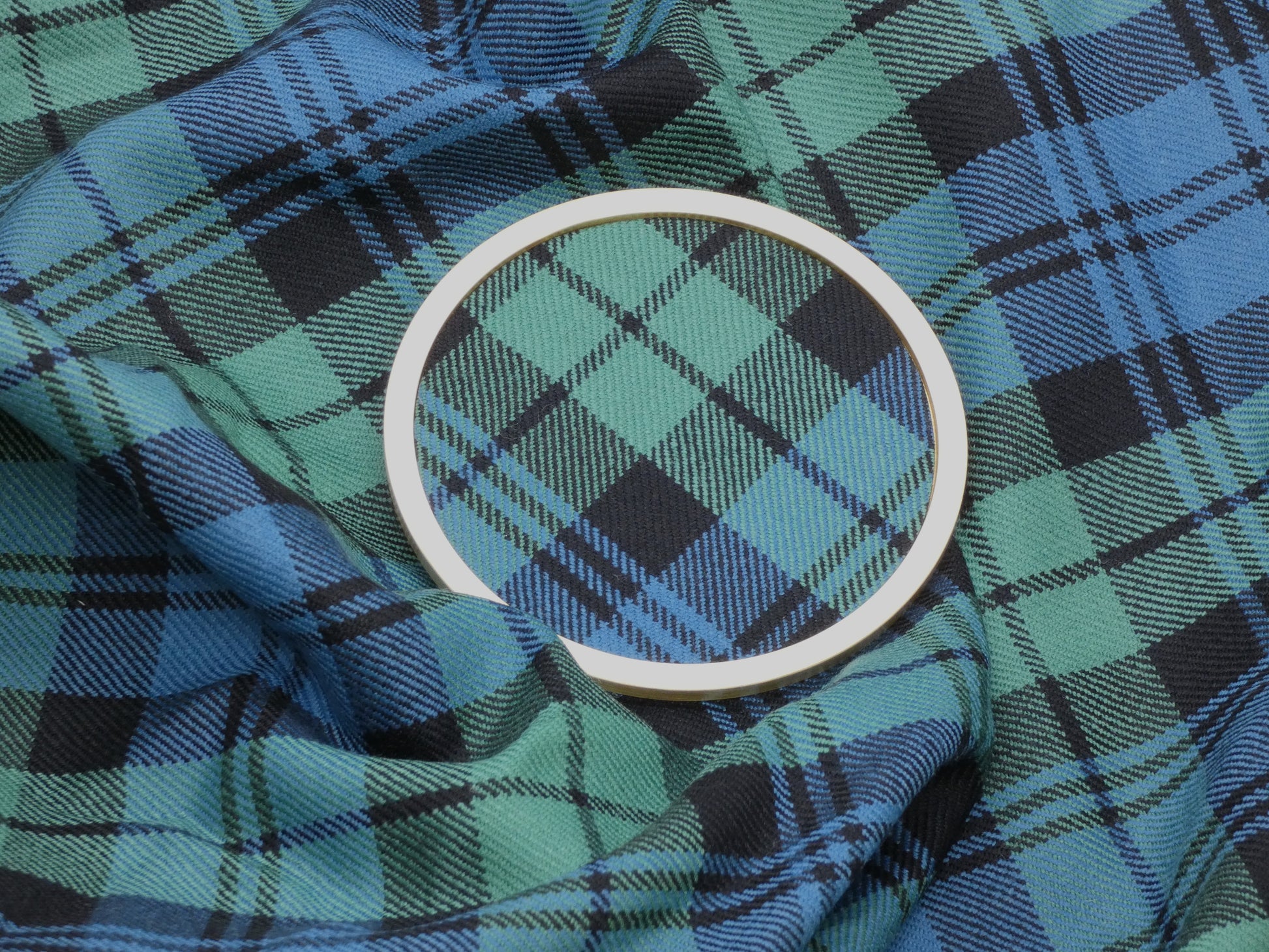Campbell Ancient Tartan Brass Coaster on wool tartan Fabric