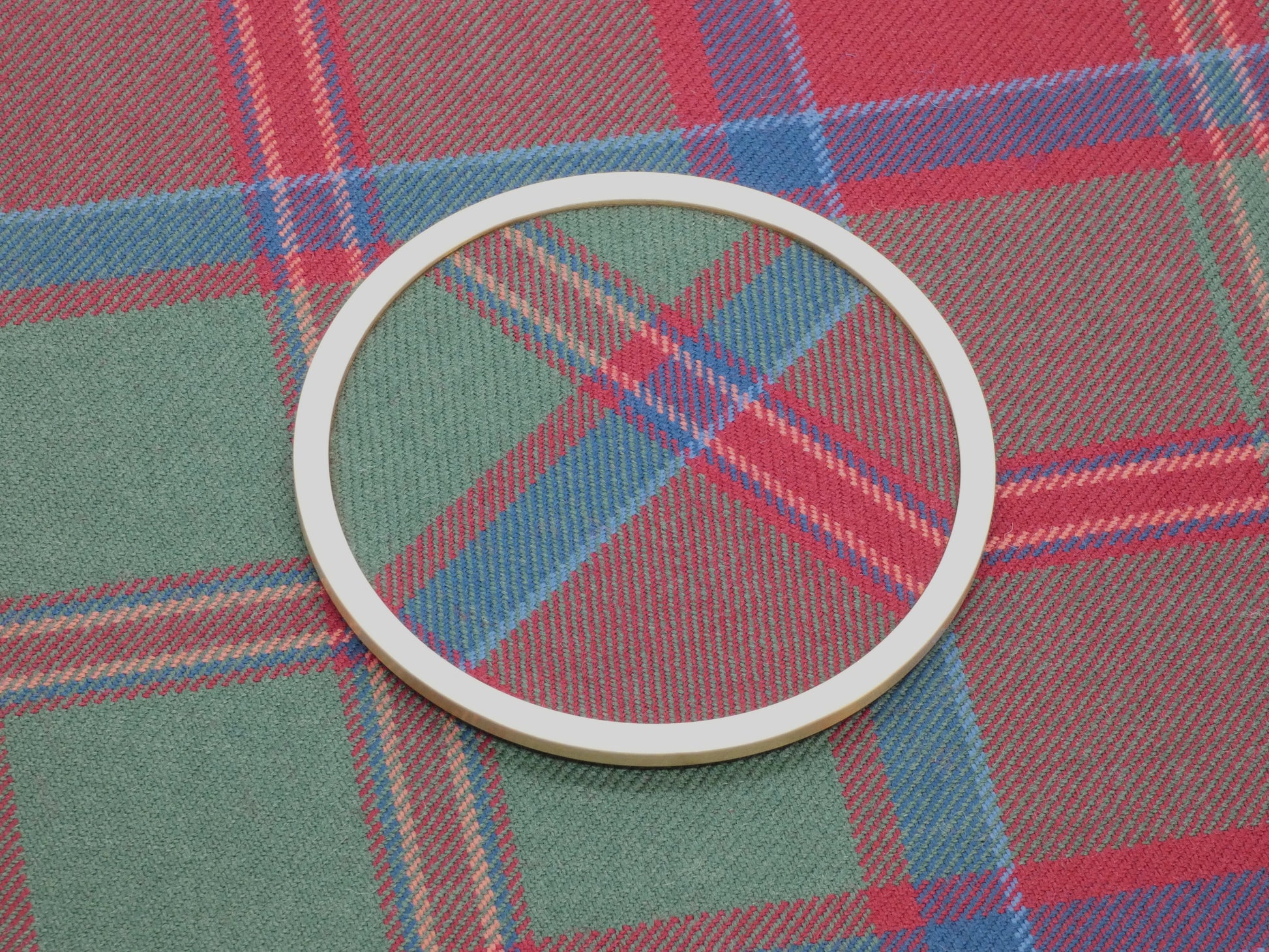MacDonald Muted Tartan Brass Coaster on Tartan Wool Fabric