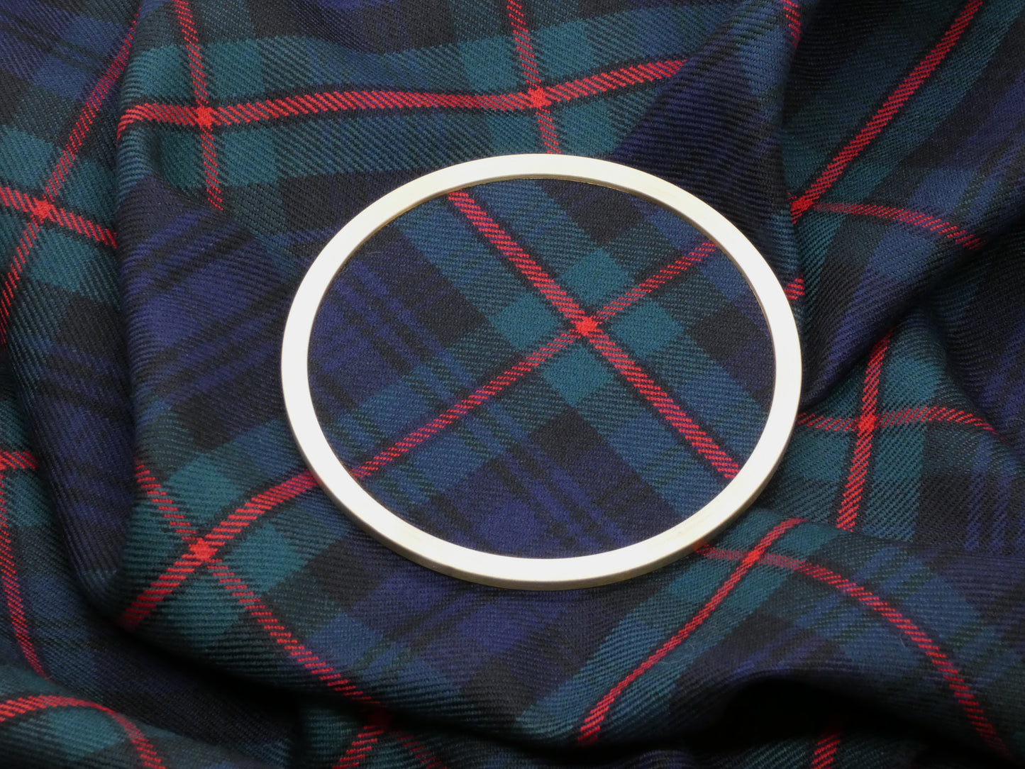 MacKinlay Modern Tartan Brass Coaster on Tartan Wool Fabric