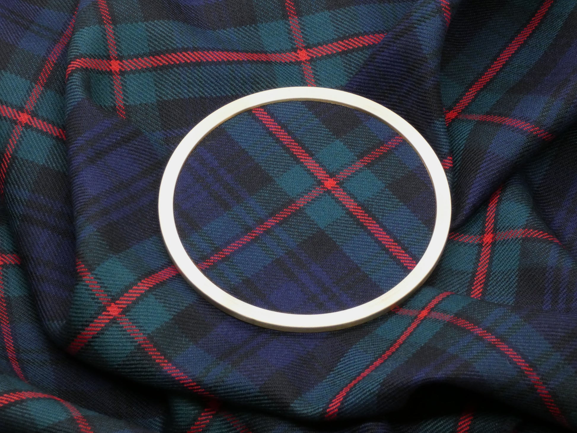 MacKinlay Modern Tartan Brass Coaster on Tartan Wool Fabric