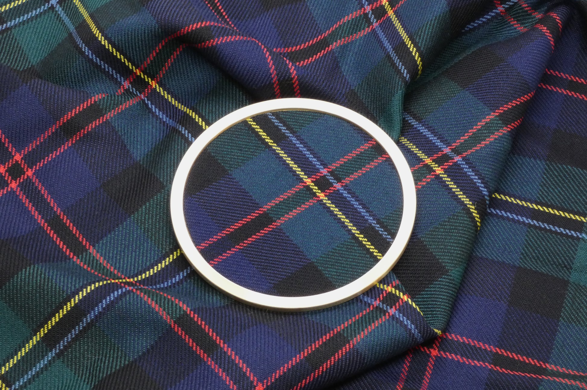 Malcolm Tartan Brass Coaster on Tartan Wool Fabric