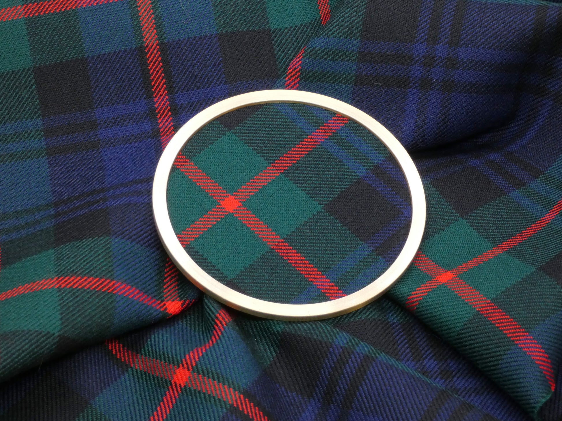 Murray Modern Tartan Brass Coaster on Tartan Fabric