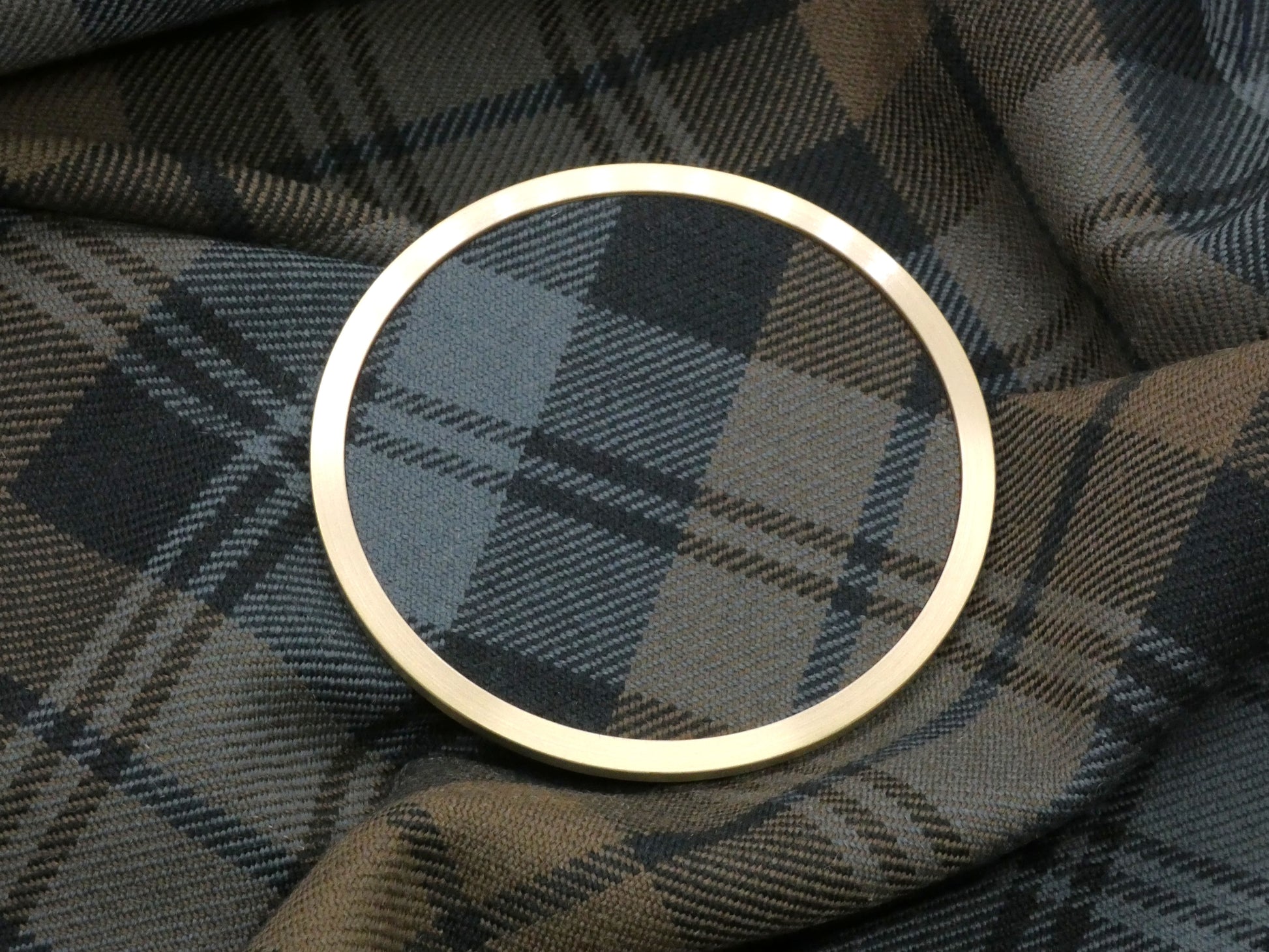 Weathered Black Watch Tartan Brass Coaster on Fabric